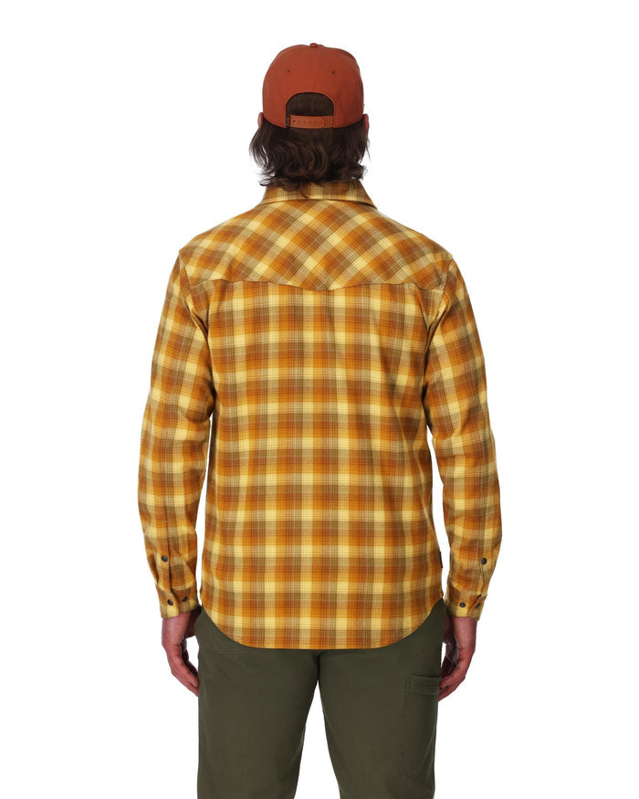 Person wearing a yellow plaid shirt and brown cap on a white background