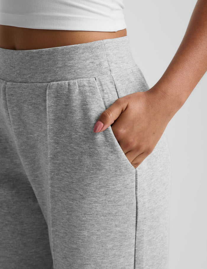 Close-up of woman wearing Gray SoftSpring™ Wide Leg Pant 29" with hand in slant pocket, paired with a white top.