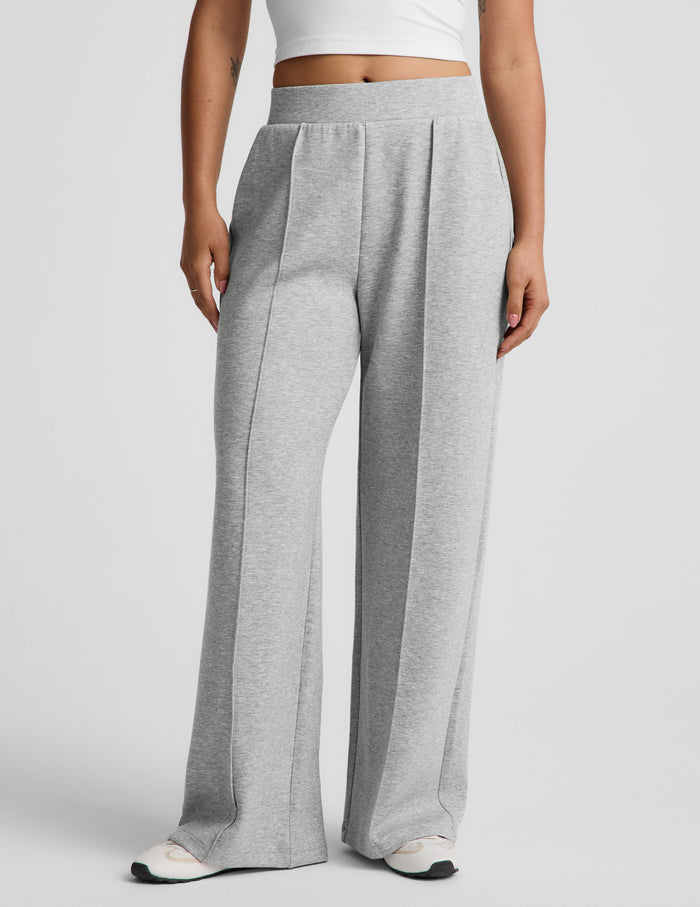 Woman wearing Gray SoftSpring™ Wide Leg Pant 29" with pintuck folds, paired with a white cropped tank top.