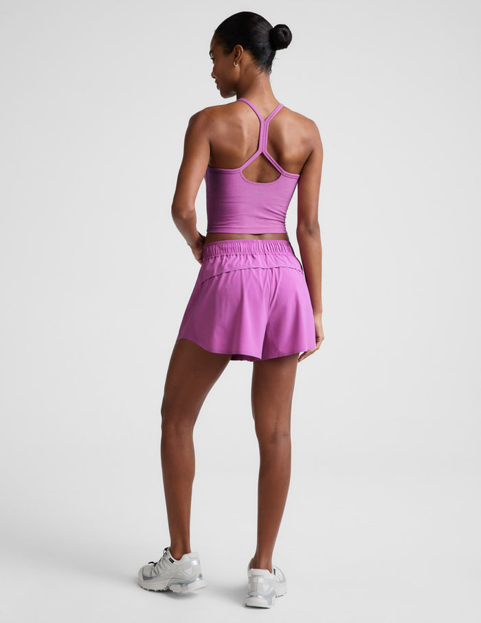 Rear view of woman wearing Pink Solemate™ 2.5" Short with a matching tank top and white sneakers.