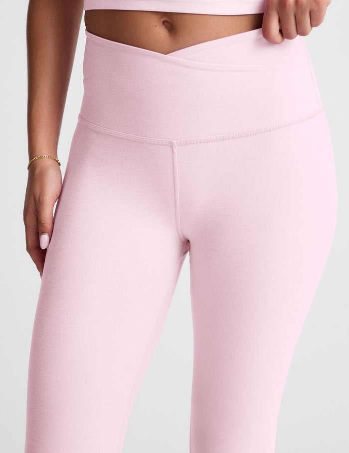 Pink leggings worn by a person on a light gray background