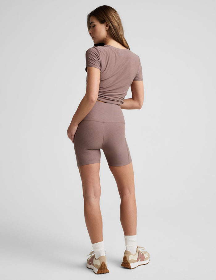 Rear view of Blush Spacedye Keep Pace 5" Pocket Short, highlighting the high-waisted, snug fit and mid-thigh length.