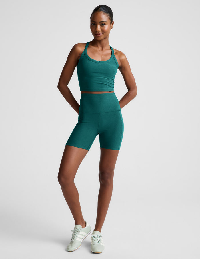 Woman wearing Teal Spacedye™ Keep Pace 5" Pocket Short paired with a matching crop tank and mint sneakers.