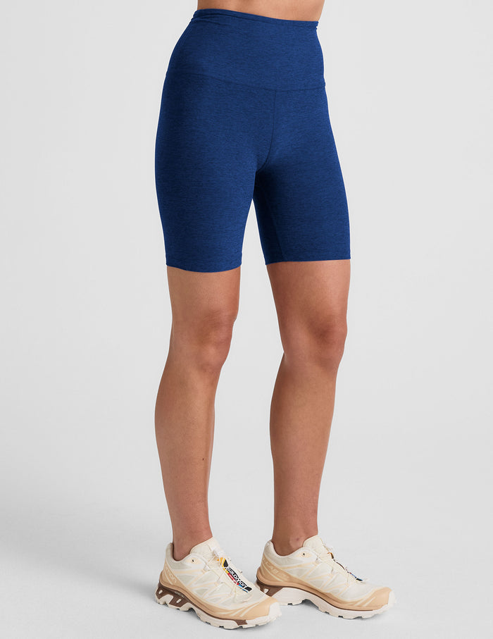 Model wears navy marled Spacedye Keep Pace 7" Short with a high waistband and snug mid-thigh fit shown from the side.