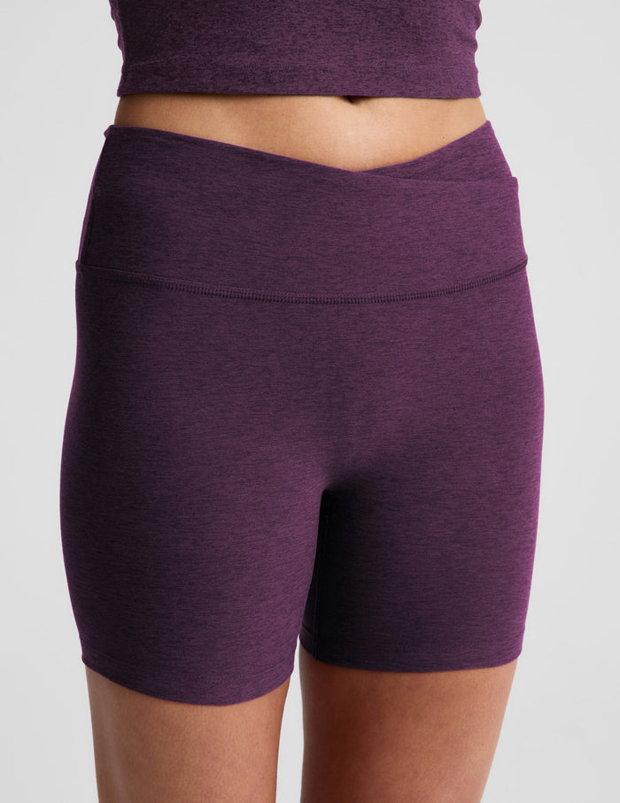 Woman wearing purple Spacedye At Your Leisure 5" Biker Short™ with overlapping waistband, paired with a matching crop top.