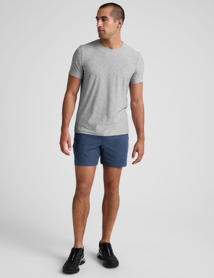 Blue marled Spacedye Unlimited Men's Short with a 7 inch inseam and relaxed fit, worn by a man with a gray t-shirt.