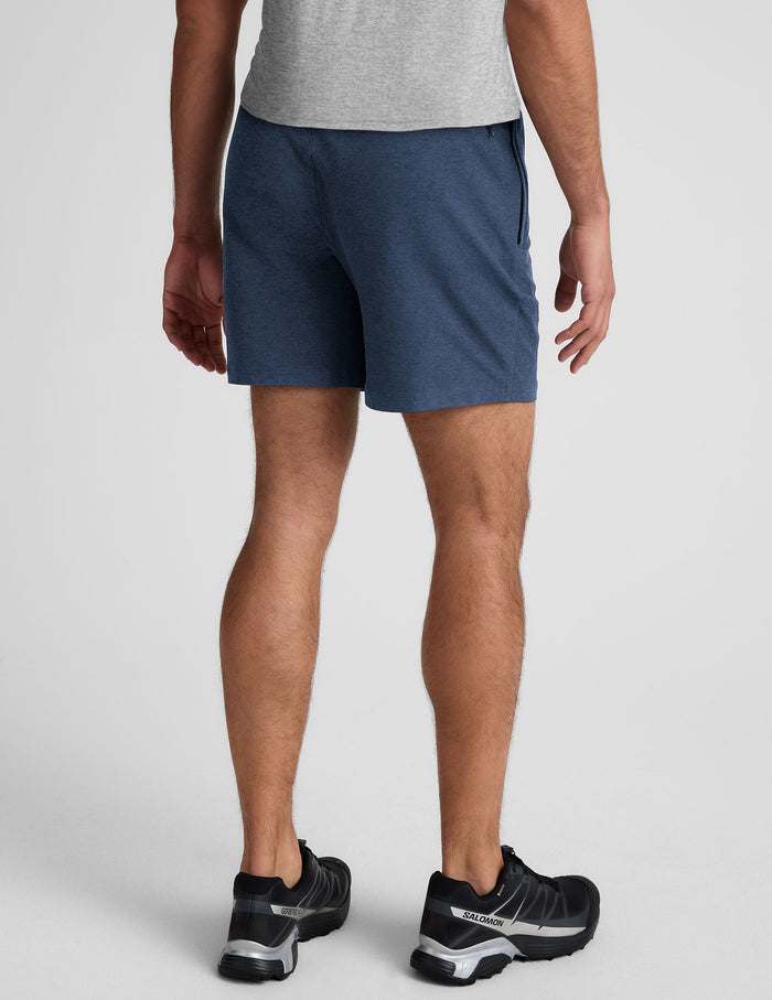 Rear view of blue marled Spacedye Unlimited Men's Short with elastic waistband and back zipper pocket, hitting mid-thigh.